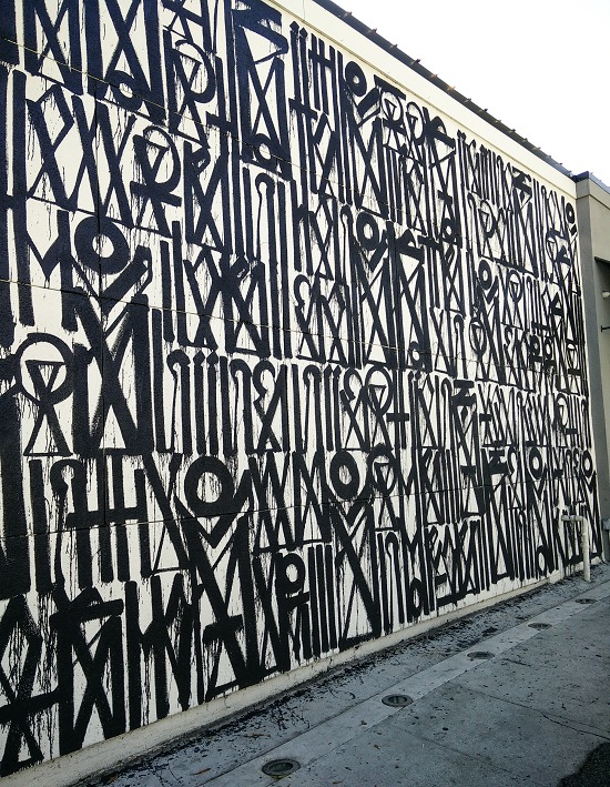 black and white graphic mural painted on a wall