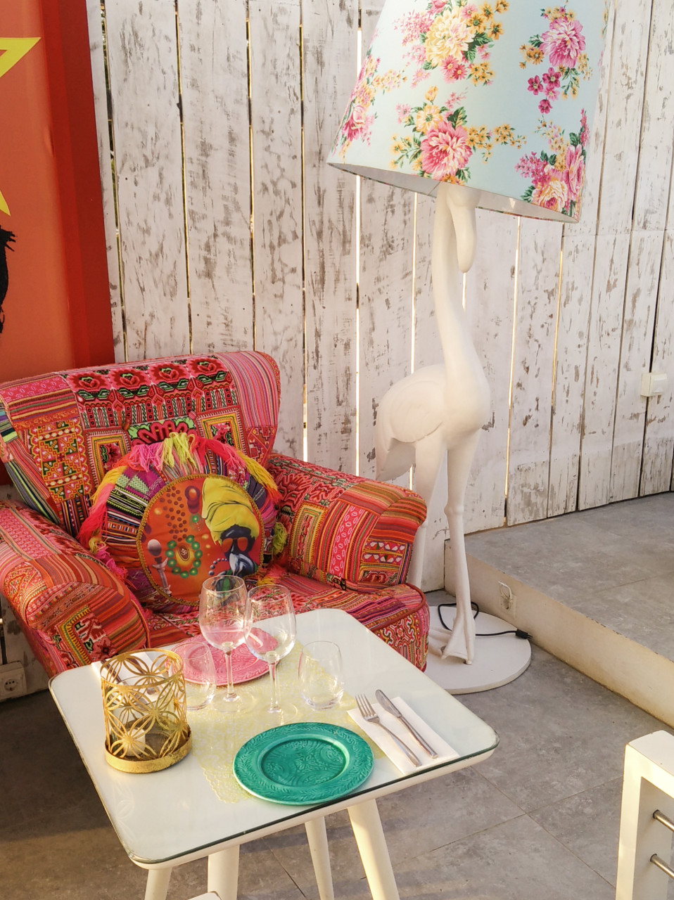 armchair next to a flamingo floor standing lamp with a floral shade
